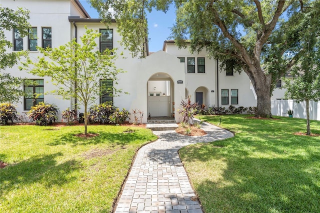 mediterranean / spanish-style house with a front yard