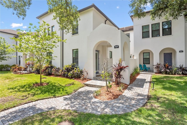 mediterranean / spanish home featuring a front yard