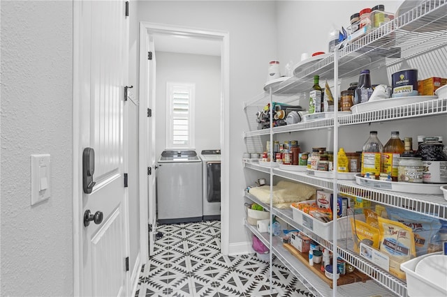 pantry featuring washing machine and clothes dryer