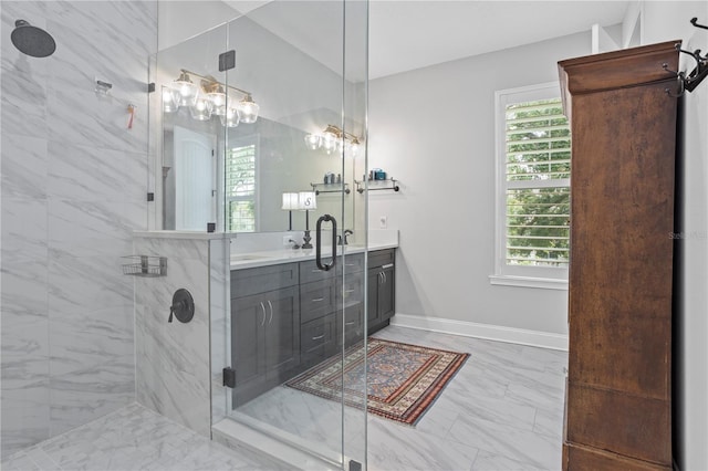 bathroom featuring vanity, plenty of natural light, and a shower with shower door