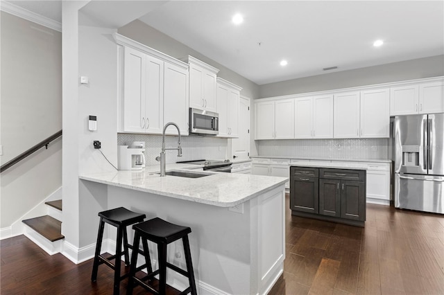 kitchen with appliances with stainless steel finishes and white cabinets