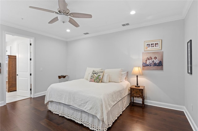 bedroom with dark wood-type flooring, visible vents, ornamental molding, and baseboards