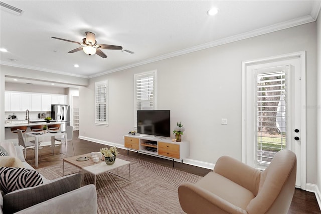 4606 W Fig St Unit 4, Tampa, FL 33609 - living area featuring crown molding, healthy amount of natural light, a ceiling fan, baseboards, and recessed lighting