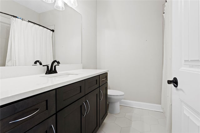 4606 W Fig St Unit 4, Tampa, FL 33609 - bathroom with toilet, vanity, baseboards, and tile patterned floors