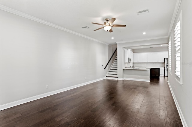 4606 W Fig St Unit 4, Tampa, FL 33609 - unfurnished living room featuring a ceiling fan, stairway, dark wood-style flooring, a sink, and recessed lighting