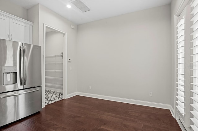4606 W Fig St Unit 4, Tampa, FL 33609 - kitchen with stainless steel refrigerator with ice dispenser, dark wood-type flooring, baseboards, white cabinetry, and recessed lighting