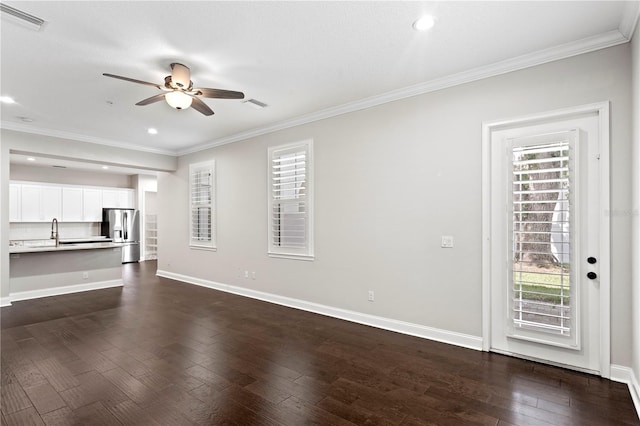 4606 W Fig St Unit 4, Tampa, FL 33609 - unfurnished living room featuring ceiling fan, crown molding, dark wood-style flooring, a sink, and baseboards