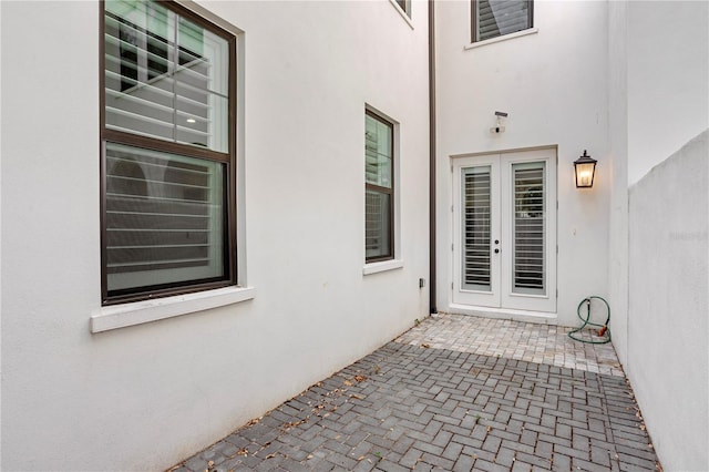 4606 W Fig St Unit 4, Tampa, FL 33609 - view of exterior entry with french doors, stucco siding, and a patio area