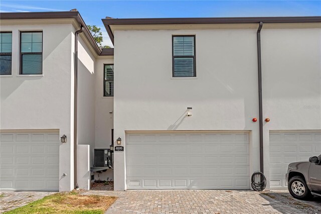 4606 W Fig St Unit 4, Tampa, FL 33609 - view of front of house with stucco siding and a garage