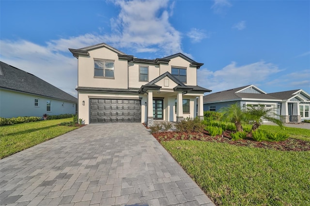 view of front of house with a front lawn and a garage