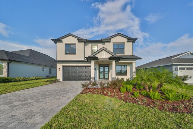 view of front of property featuring a garage and a front yard