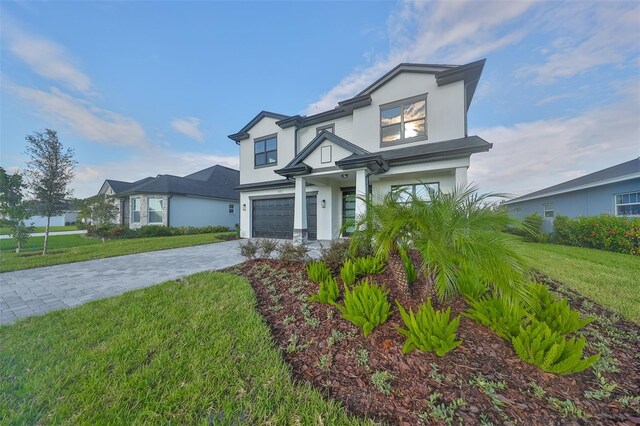 view of front of property with a front yard and a garage