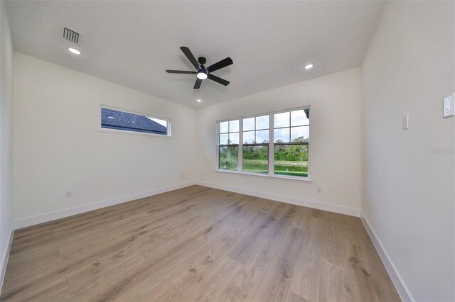 spare room featuring ceiling fan and light hardwood / wood-style flooring