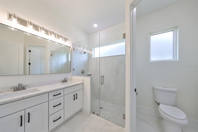 bathroom with a shower with door, toilet, vanity, and plenty of natural light