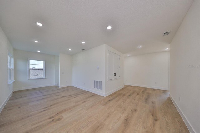 unfurnished room with light hardwood / wood-style flooring