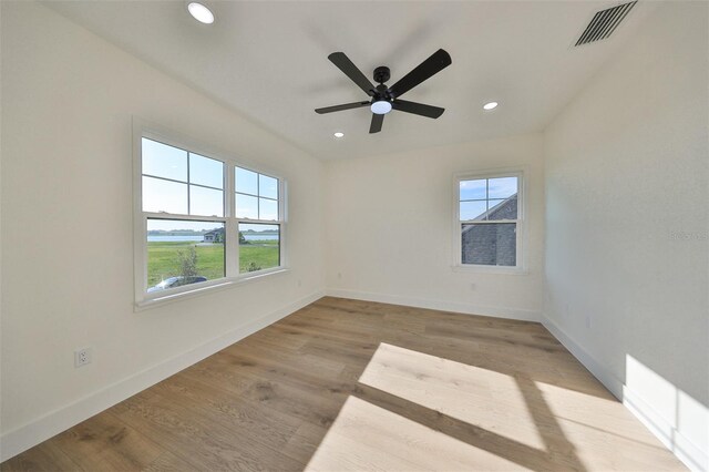 spare room featuring ceiling fan and light hardwood / wood-style flooring