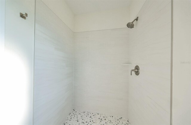 bathroom with a tile shower