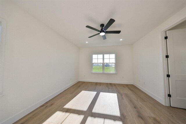 unfurnished room featuring ceiling fan and light wood-type flooring