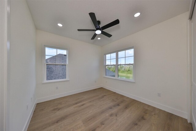 spare room with light wood-type flooring and ceiling fan