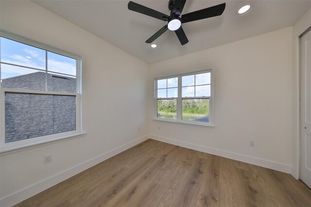 spare room with light hardwood / wood-style floors and ceiling fan