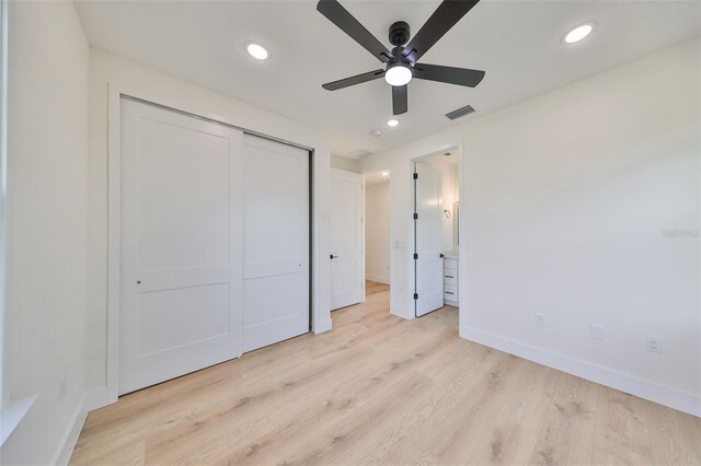 unfurnished bedroom with a closet, light hardwood / wood-style floors, and ceiling fan