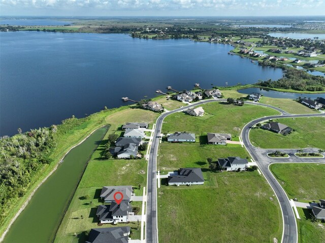 birds eye view of property with a water view