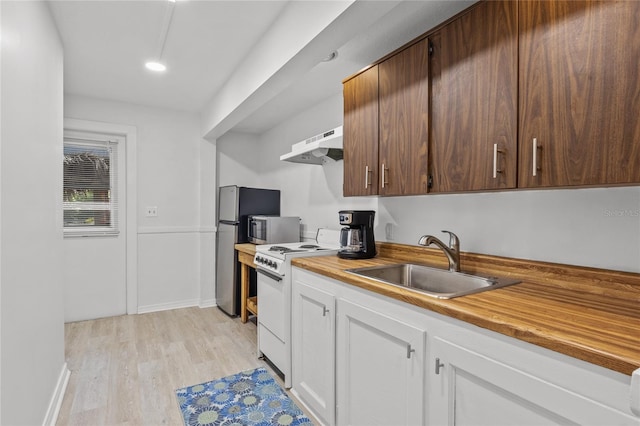 kitchen with ventilation hood, sink, light wood-type flooring, white cabinetry, and stainless steel appliances