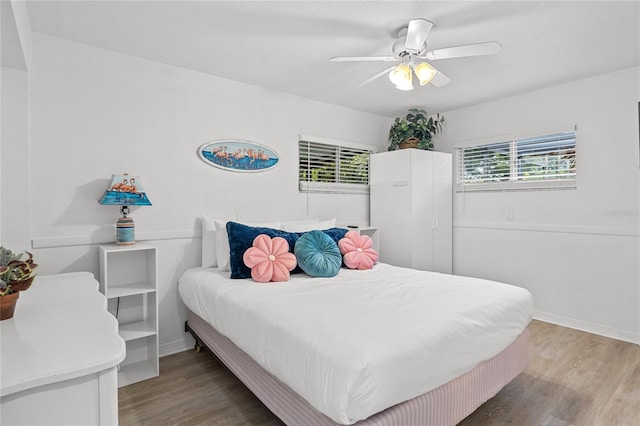 bedroom with hardwood / wood-style flooring and ceiling fan