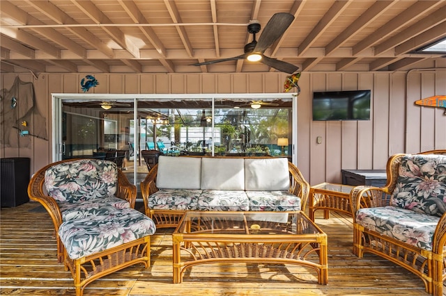 sunroom featuring beamed ceiling, ceiling fan, and wood ceiling