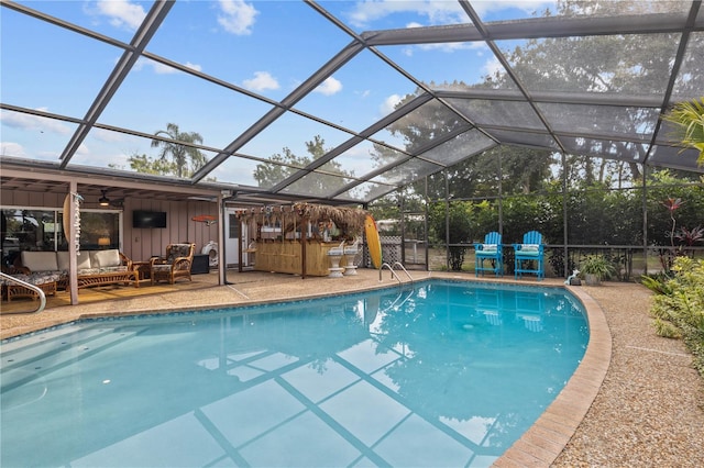 view of pool featuring glass enclosure, a jacuzzi, ceiling fan, and a patio