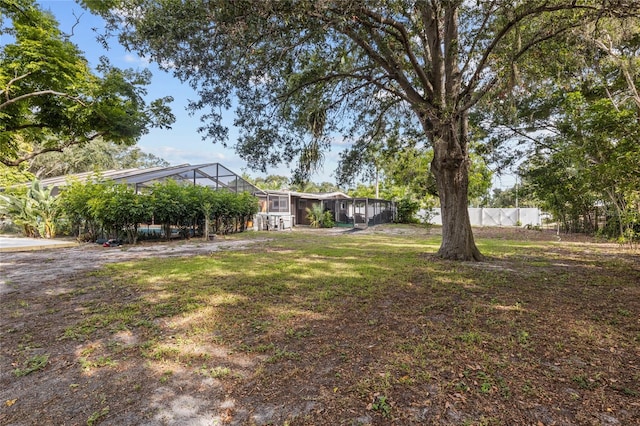 view of yard featuring glass enclosure