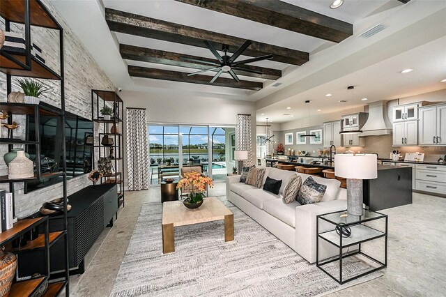 tiled living room with ceiling fan and beam ceiling