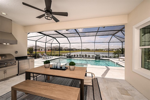 outdoor pool with a patio, glass enclosure, outdoor dining area, a grill, and exterior kitchen