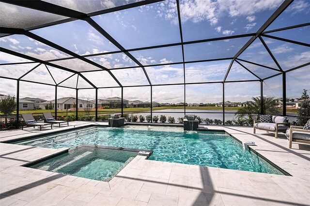 view of swimming pool featuring an in ground hot tub, a patio, pool water feature, and a lanai