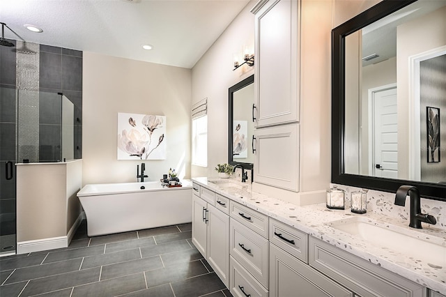 bathroom featuring double vanity, tile flooring, and independent shower and bath