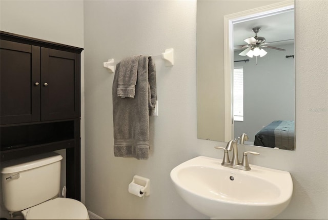 bathroom featuring ceiling fan, toilet, and sink