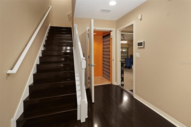 stairway with hardwood / wood-style floors