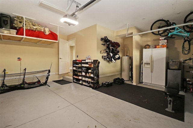 garage featuring water heater, a garage door opener, and white refrigerator with ice dispenser