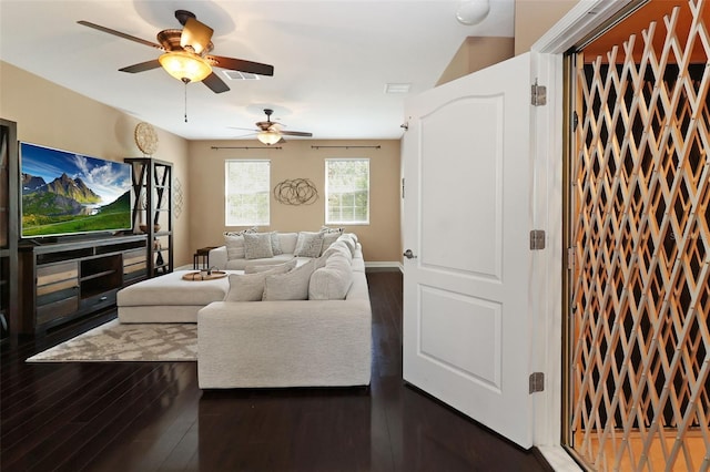 living room featuring dark hardwood / wood-style floors, ceiling fan, and lofted ceiling