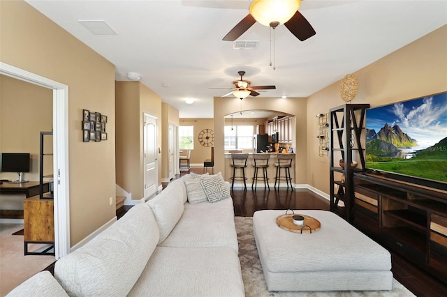 living room with ceiling fan and wood-type flooring