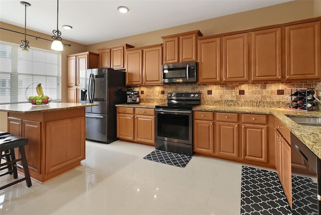 kitchen featuring stainless steel appliances, a kitchen island, decorative light fixtures, decorative backsplash, and light tile patterned floors