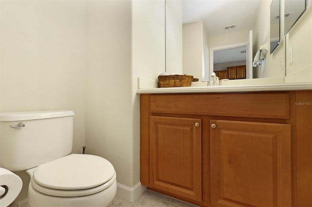 bathroom with tile patterned flooring, vanity, and toilet