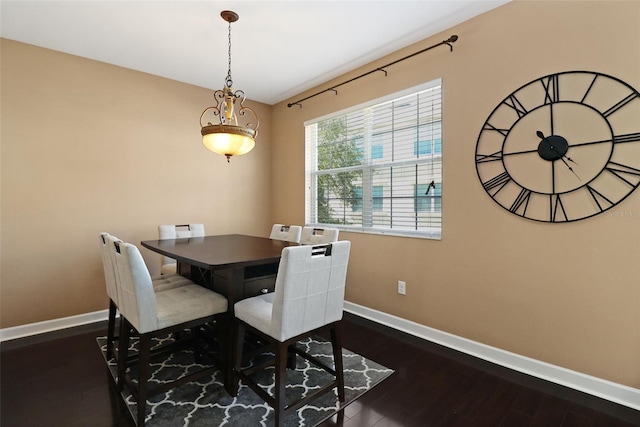 dining space with dark wood-type flooring