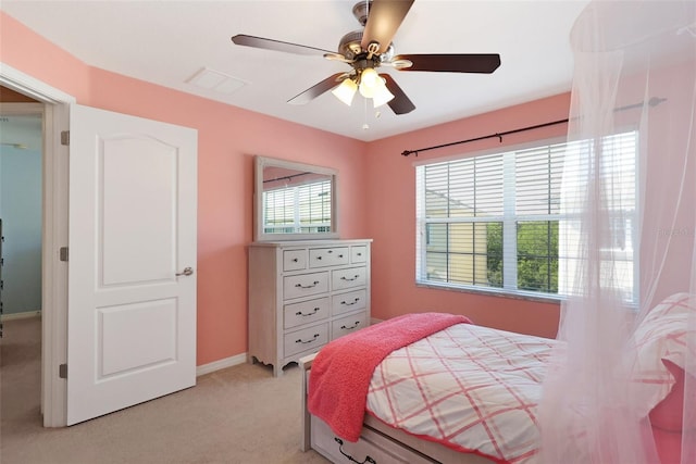 bedroom featuring light colored carpet and ceiling fan