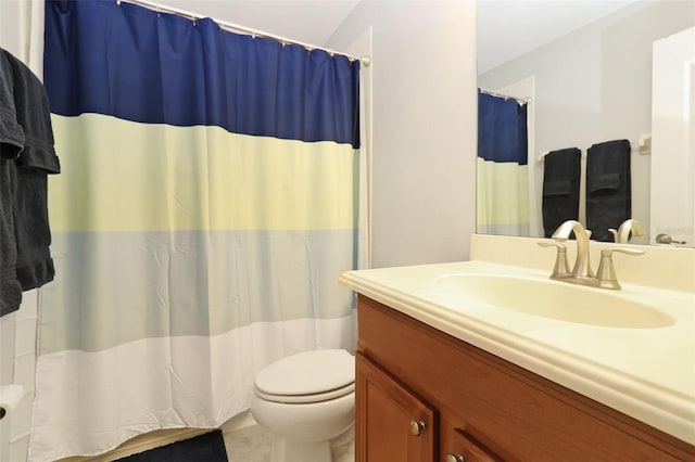 bathroom featuring curtained shower, vanity, and toilet