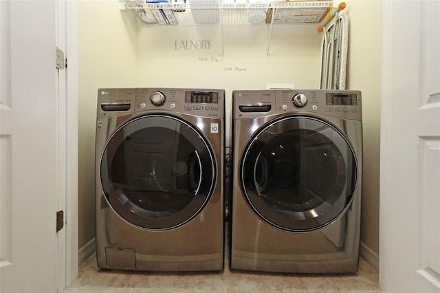 laundry area featuring washing machine and clothes dryer