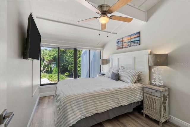 bedroom featuring ceiling fan, lofted ceiling, and wood-type flooring