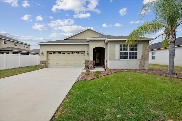 single story home with a garage and a front lawn