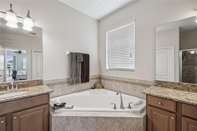 bathroom featuring vanity, ceiling fan, and plus walk in shower