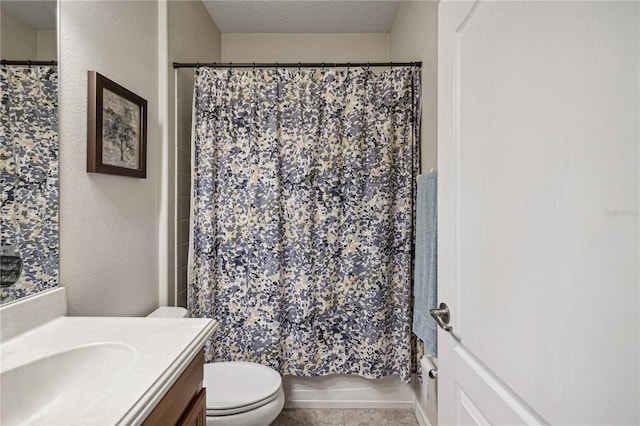 full bathroom with a textured ceiling, tile floors, shower / bath combination with curtain, vanity, and toilet